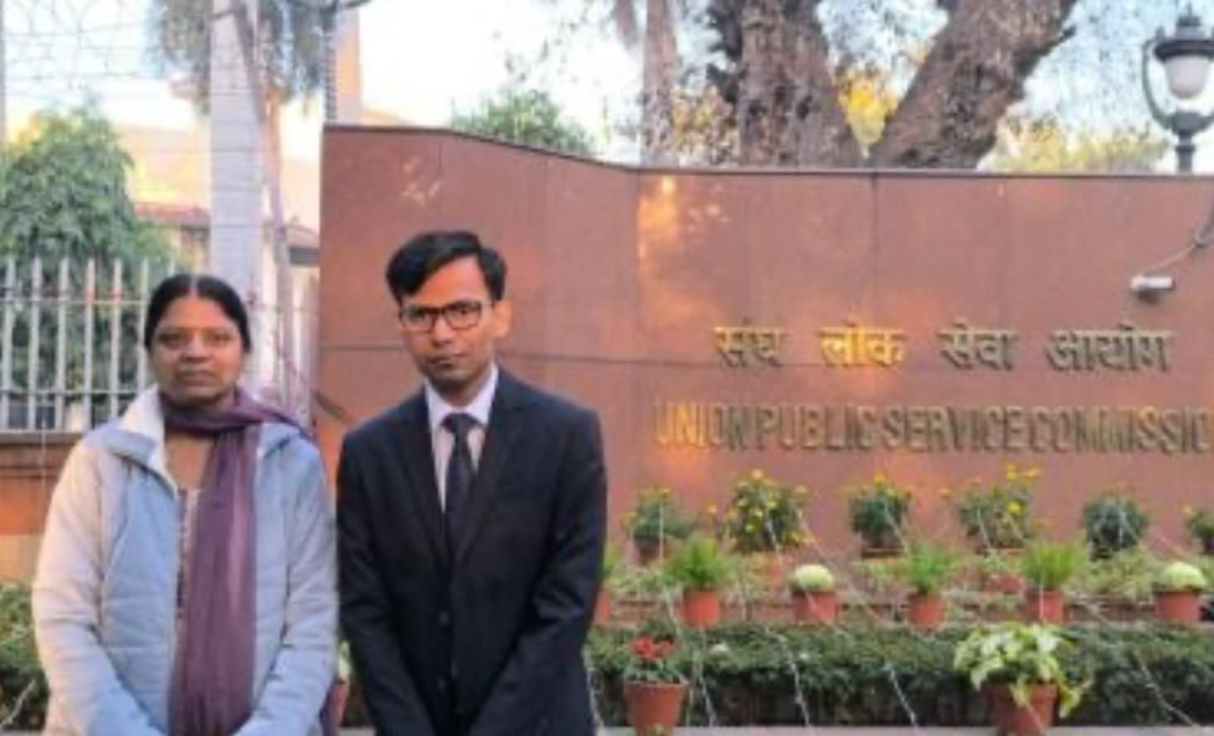 Manu Garg and his mother standing in front of the Union Public Service Commission (UPSC) building.