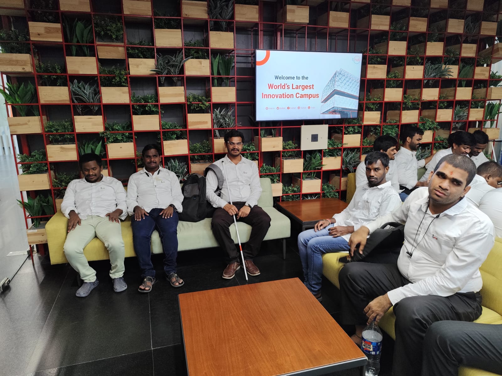 Visually impaired trainees are seated in the lounge area.