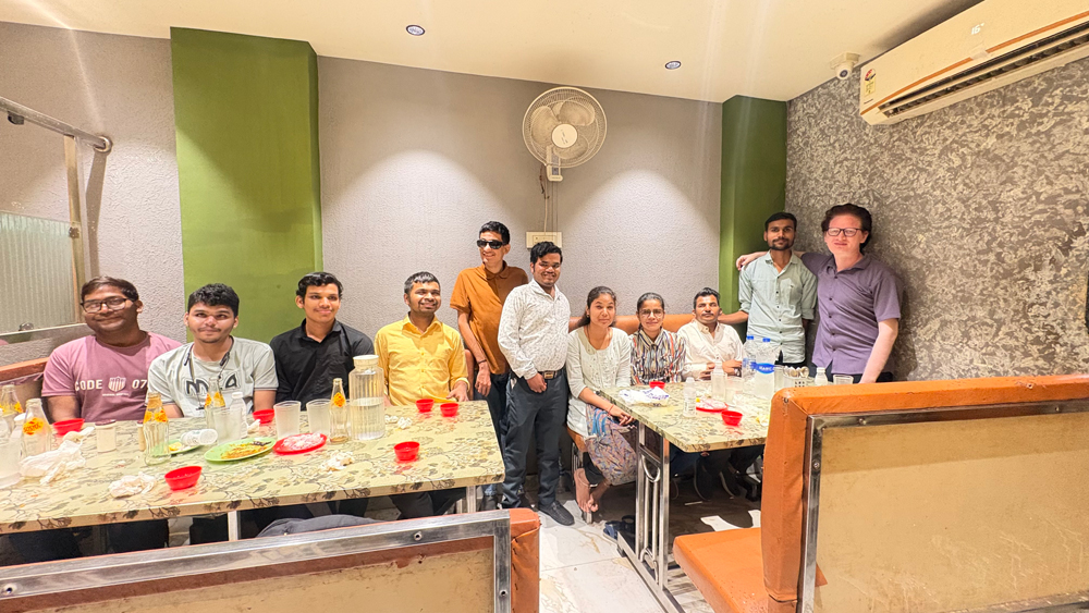 A Group photo of visually impaired students and trainers at the restaurant.